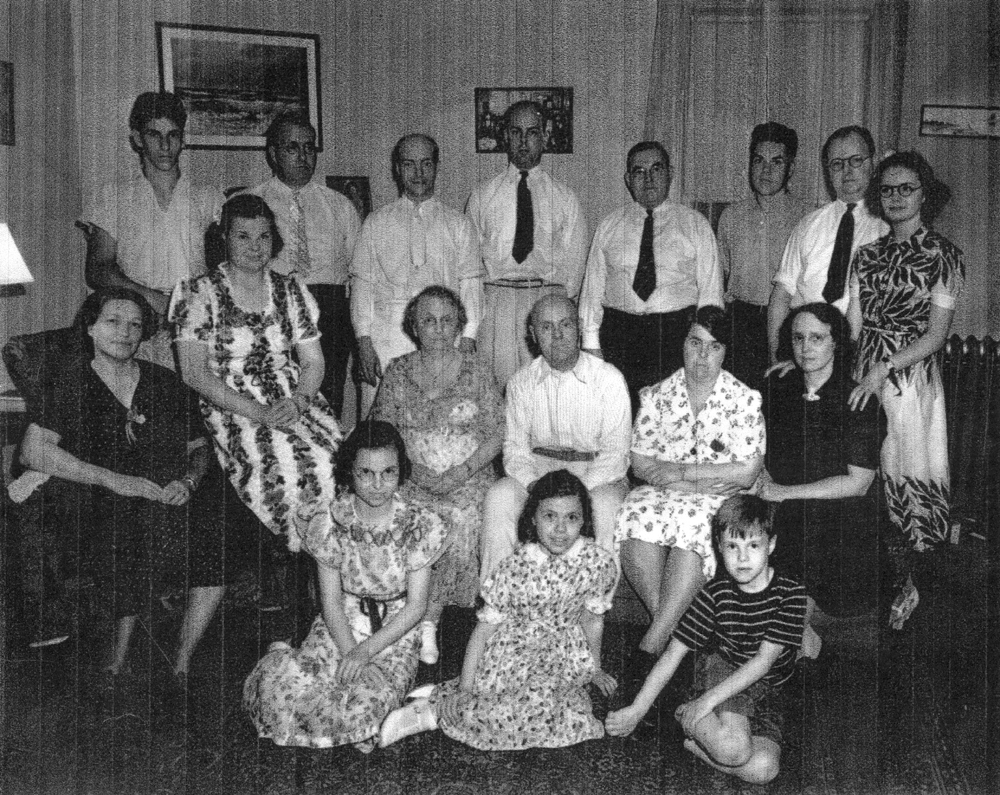 Family picture, possibly at time of John Herbert DeVoe and Edith Tompkins 50th wedding anniversary. Scanned copy sent April 2004 by Sandra M. DeVoe.
Move the cursor over the image to see the name of each individual. (The descriptions are those of Sandra DeVoe.) Click on a person to open the page for that person.